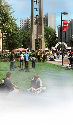 image of students outside on the lawn next to bell tower.