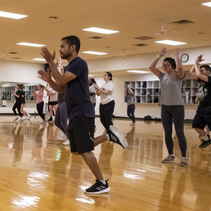 People mid workout in the group fitness room