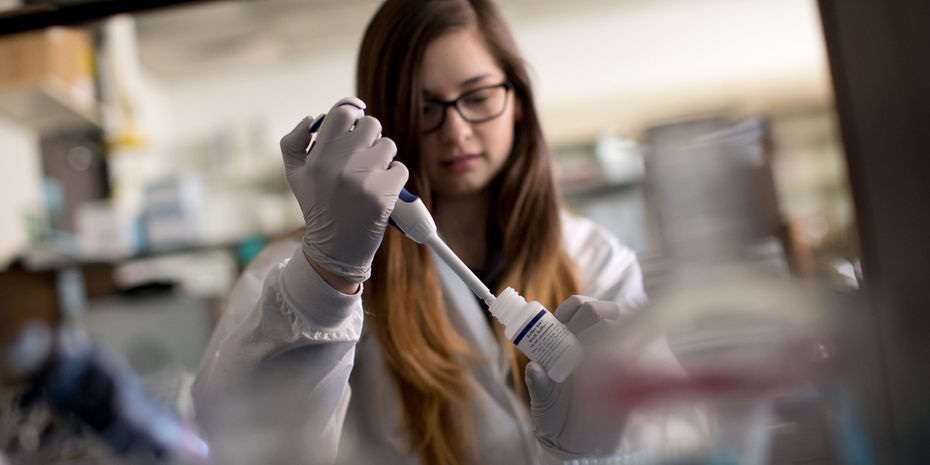 chemistry student in a lab performing an experiment