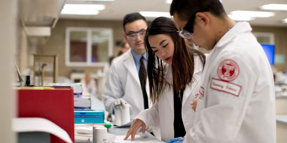 students in a pharmacy lab working on some tests. 