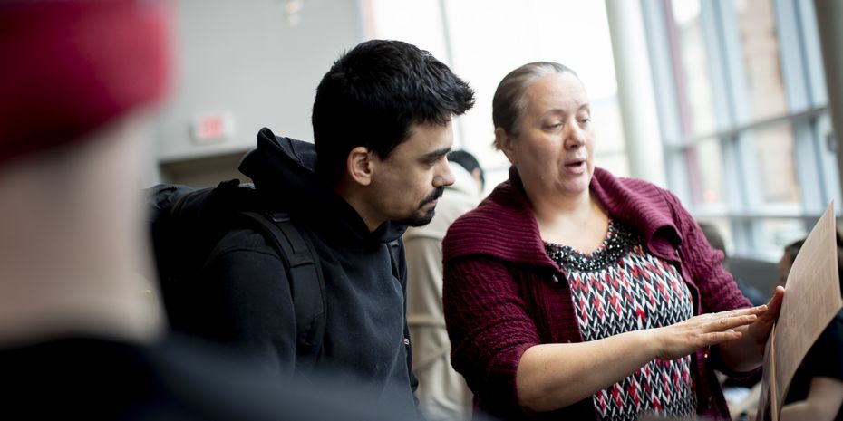 A Temple student discusses a research plan with a faculty member.