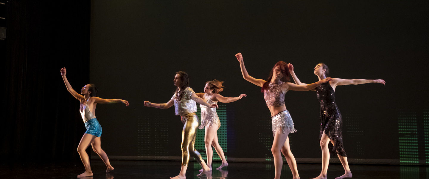 An image of four dancers on a stage during a Boyer dance recital. 