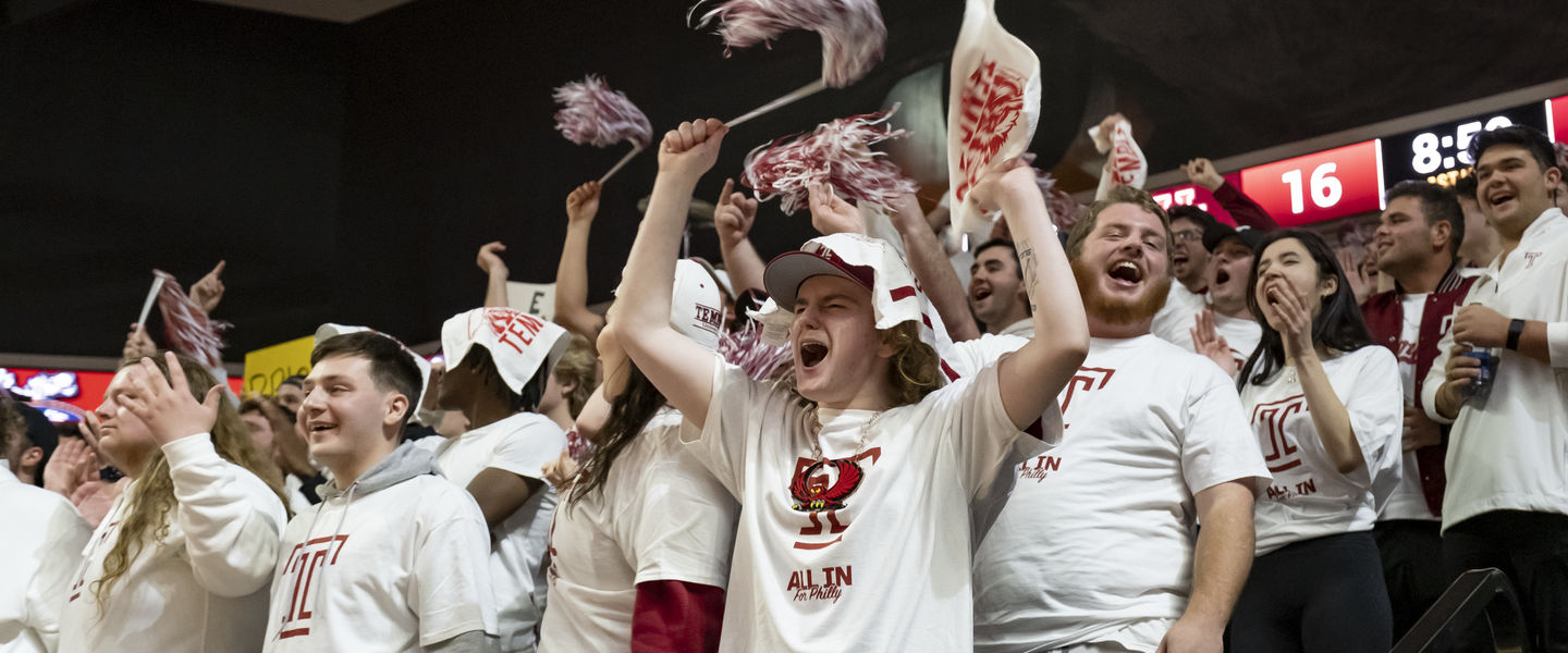 students cheering at a Temple basketball game.