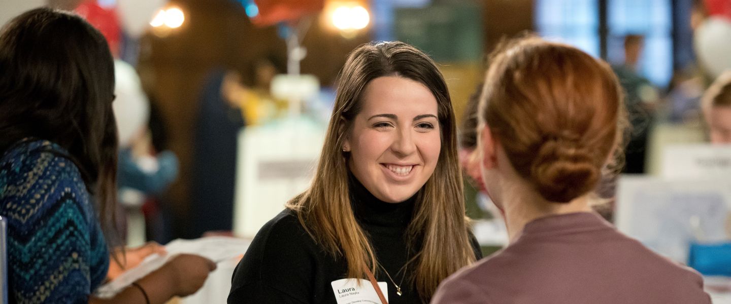 A pair of Temple students speak at a local job fair.