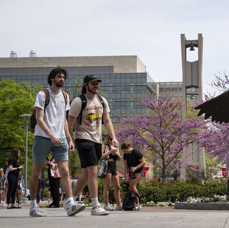 students walk across Main Campus on a spring day.