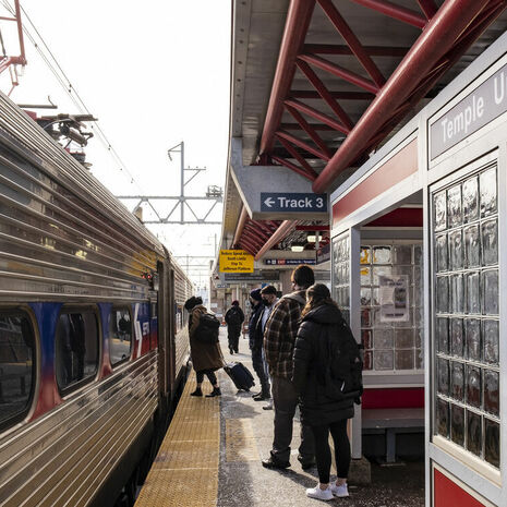 People boarding SEPTA Regional Rail at the Temple University station