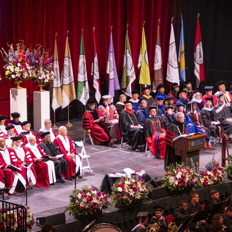 President Fry speaking at podium during Commencement