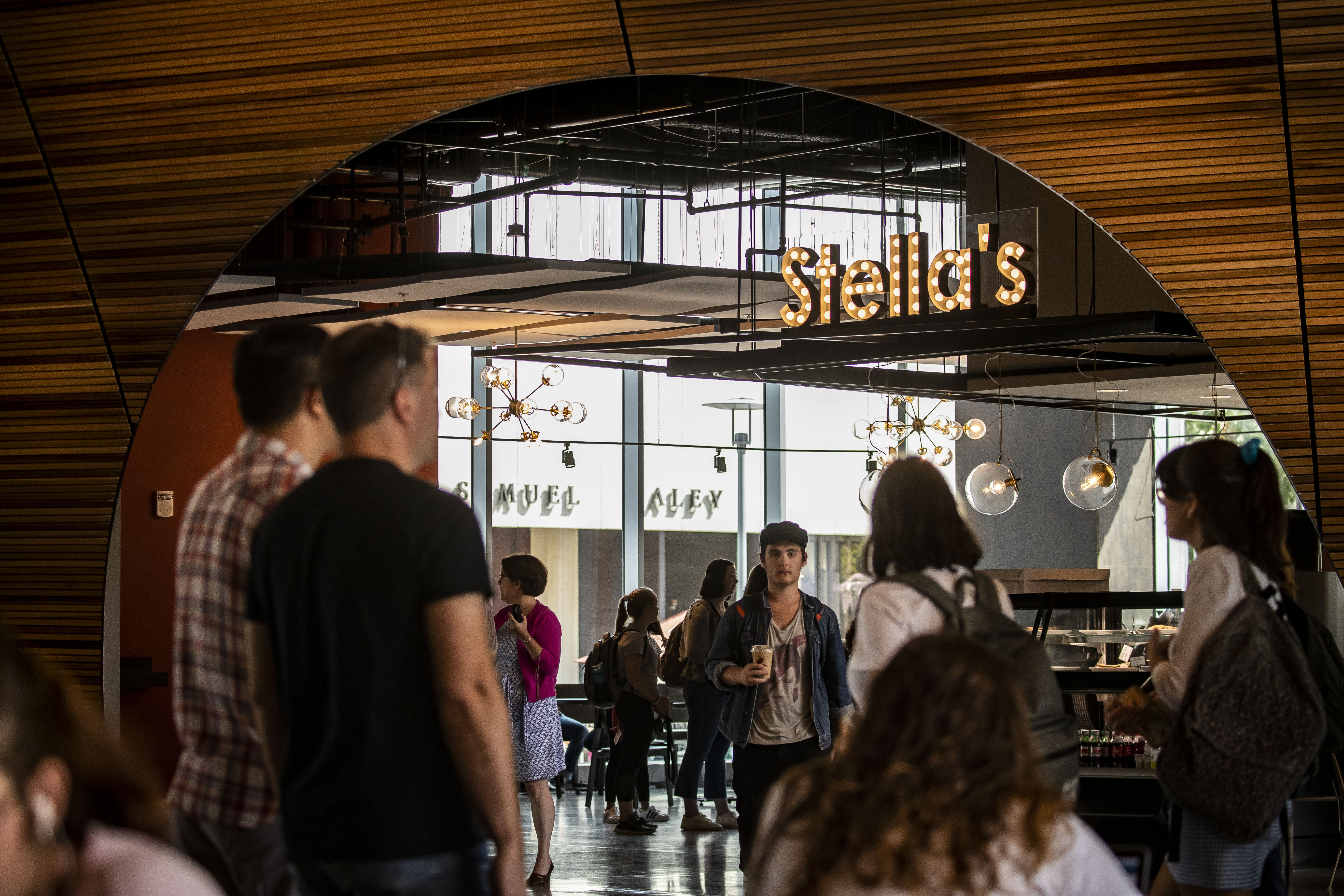 students gathering at Stella's Cafe inside Charles Library