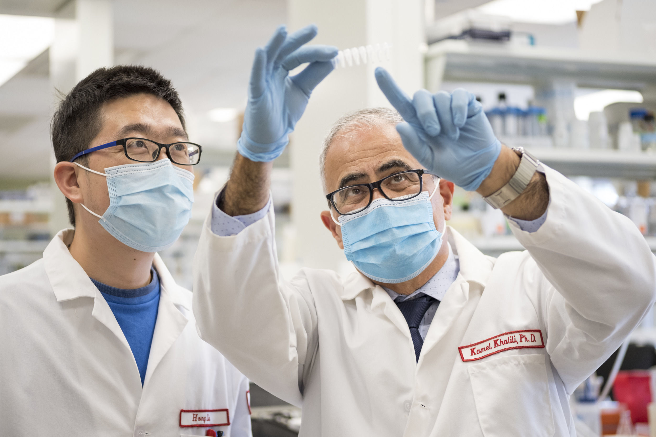 Two mean wearing gloves and masks in the lab