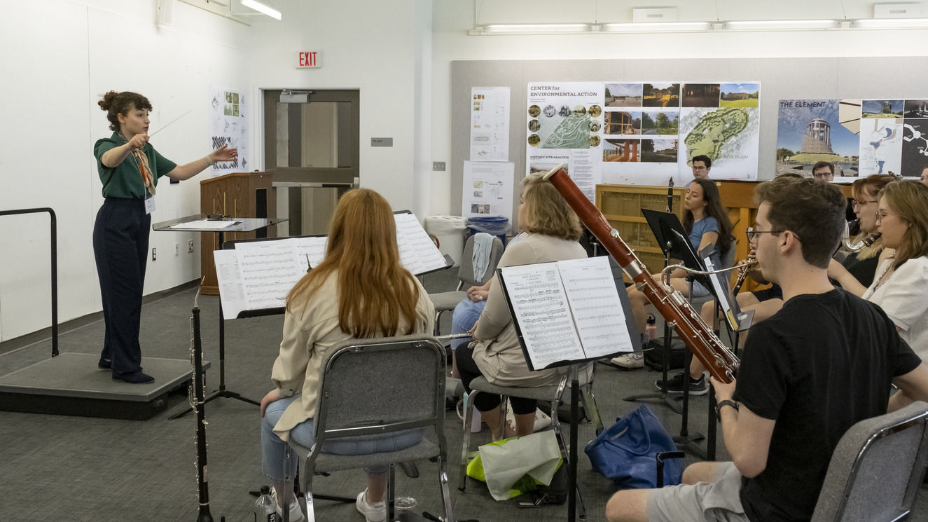 An image of individuals attending a conducting workshop. 