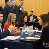 Students in suits having a discussion at a meeting. 