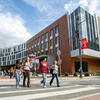 Students walking in front of the Christopher M. Barnett College of Public Health building.