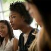 Female students engage in a classroom.