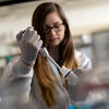 chemistry student in a lab performing an experiment