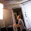 A film student setting up equipment on a film set.