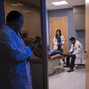 Podiatric students examine a patient.