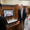 Temple dentist and student discussing the screened image of a mouth in a dental school clinic.