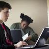 Students are concentrating on their laptops during class.