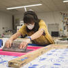 Fibers and Materials student works with equipment. 