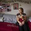 student posing in her dorm room.
