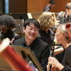 two music students playing with the orchestra