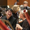 two students in the Temple band smiling and laughing