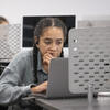 student working on her laptop in the TECH center. 