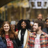 four temple students smiling and walking in Philadelphia