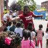 Two Temple students volunteering outdoors with elementary school students