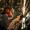 A Temple student works to craft set pieces for a theater production.