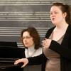 A Boyer College of Music and Dance student sings while a woman plays the piano.
