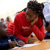 education student working with a young learner in elementary school classroom