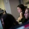 Temple students study the array of screens in the computer lab.