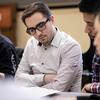 Boyer College of Music and Dance students sit in a classroom together and examine papers in front of them.