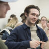 education student wearing a dark blue shirt participating in class