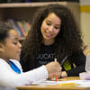 education student working with a young learner in elementary school classroom