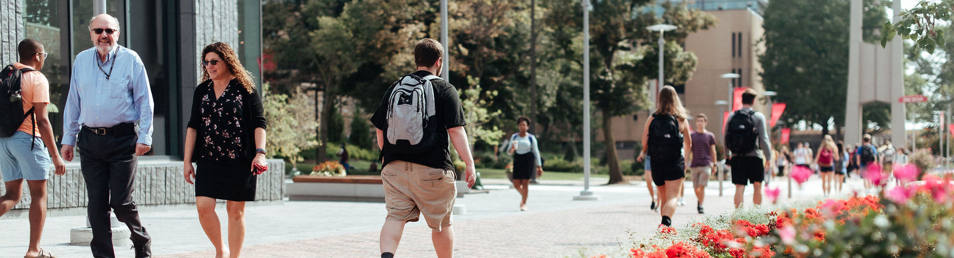 Temple students walk across Polett Walk between classes on Main Campus.