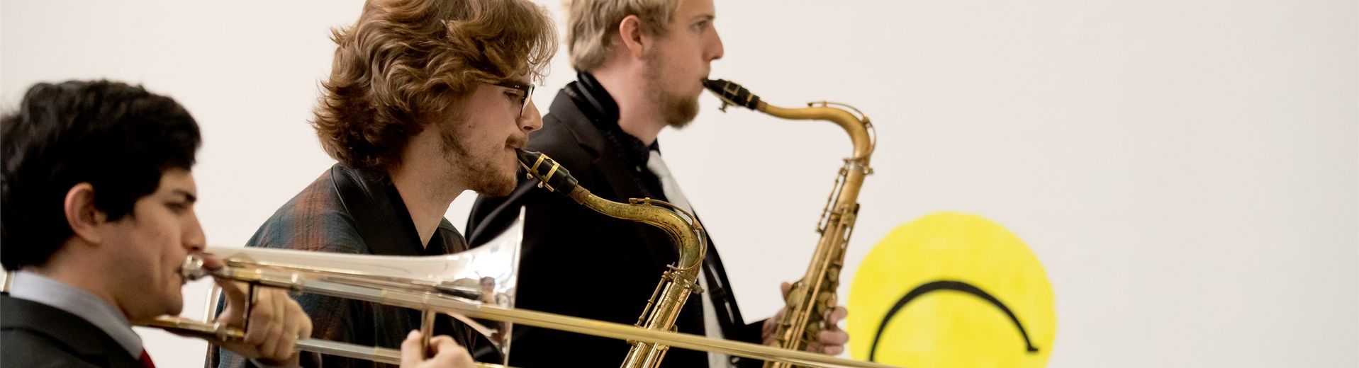 Three students playing saxaphones