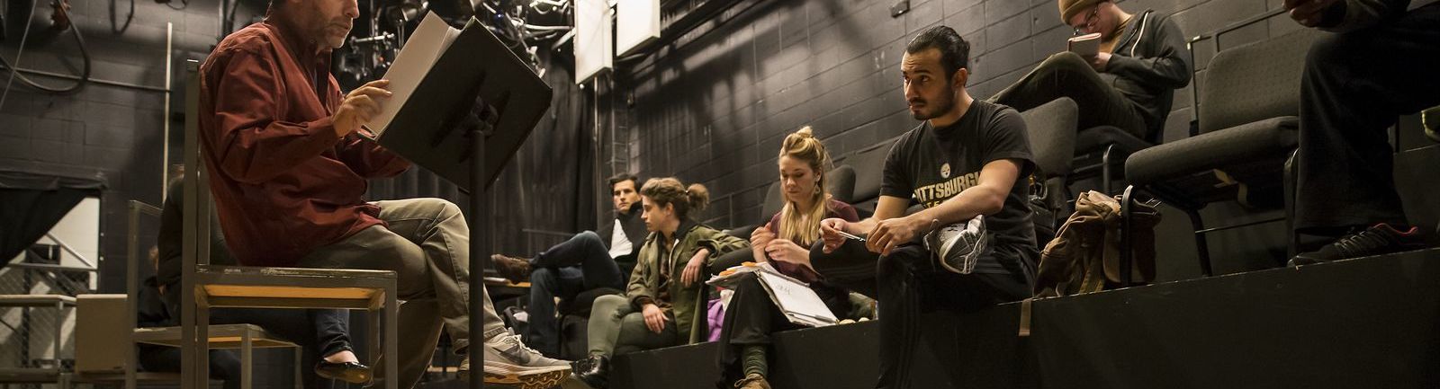 Students sitting in a class on stage.