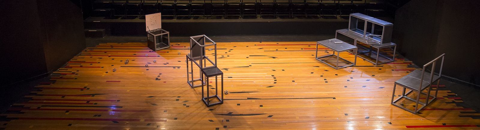 Open, metal blocks on a stage.
