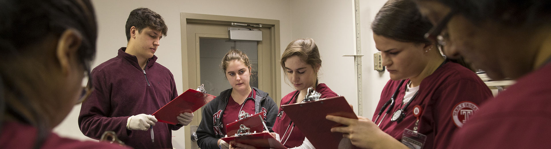 Nursing students reviewing medical charts.