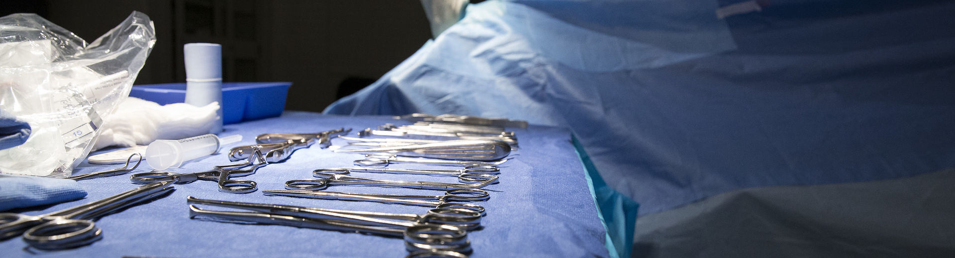 Podiatric surgical tools on a table in an operating room.
