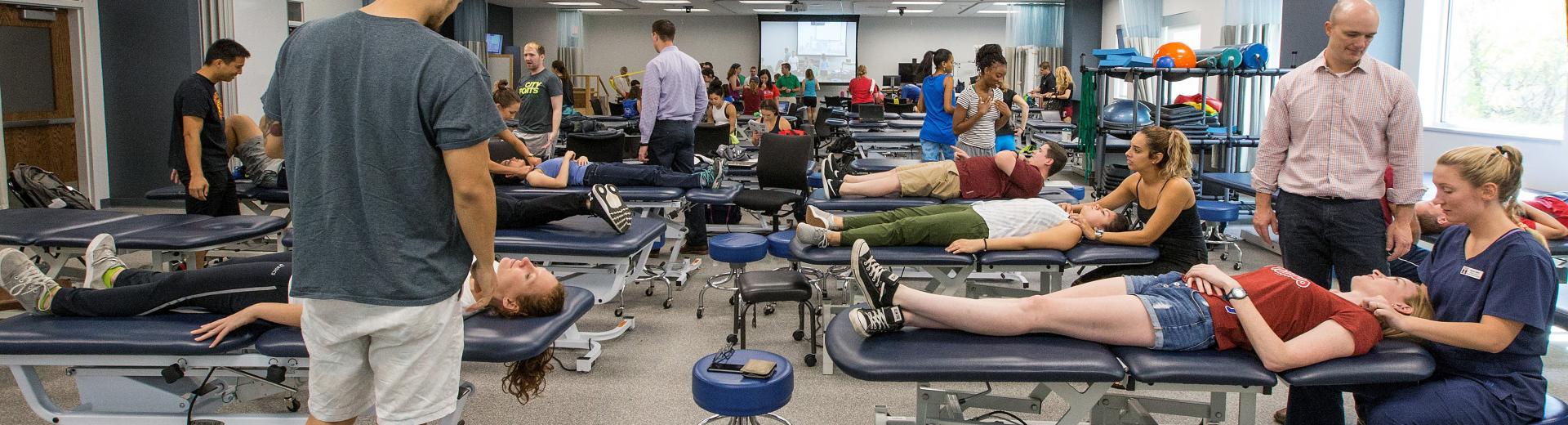 Physical therapy students practicing on patients