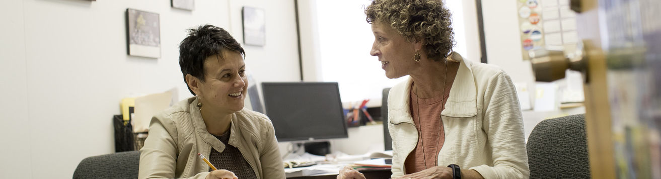 An image of two women having a conversation at a table