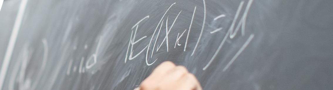 Mathematics professor writing on a chalkboard