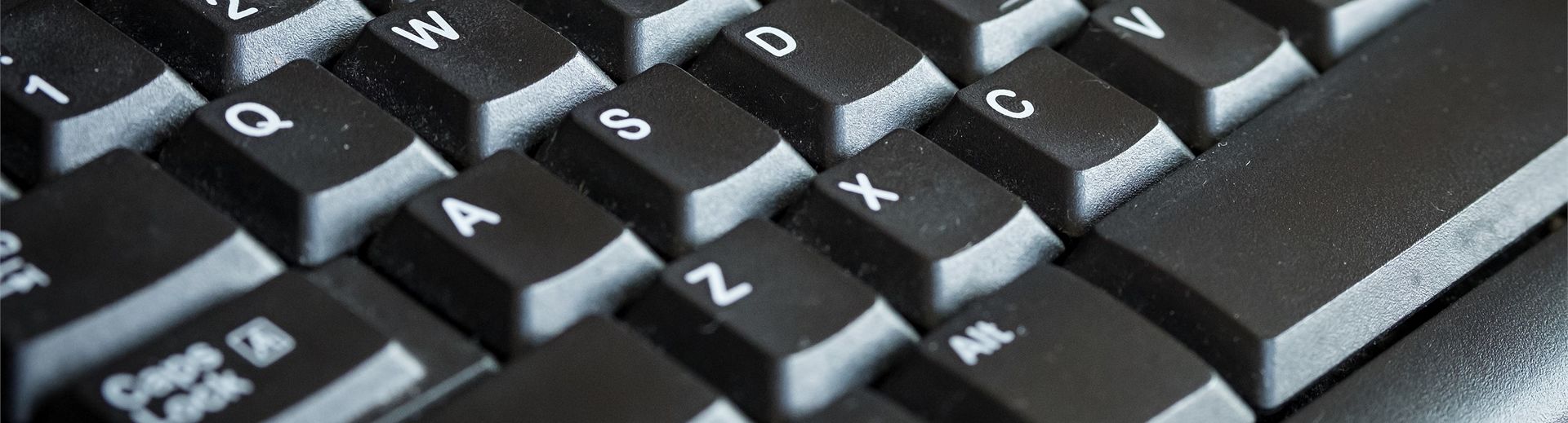 A close-up look of a grey computer keyboard.