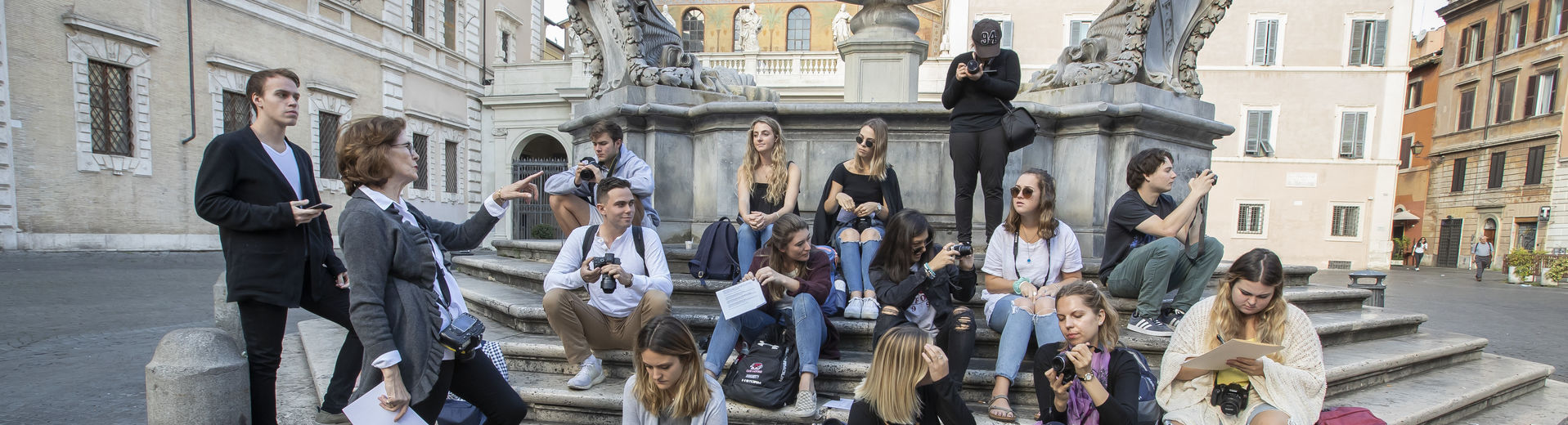 A group of Temple students gather at a fountain in Rome, Italy.