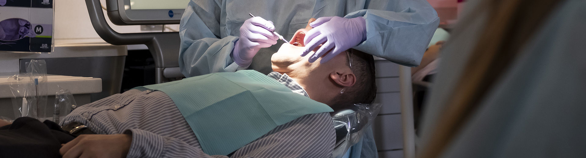 A male dental patient being treated in a clinic in the Kornberg School of Dentistry.