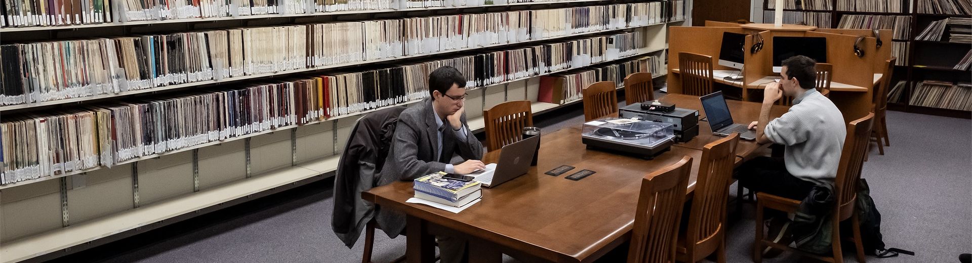 Students working at a long table in the music library.