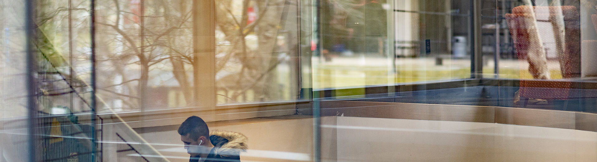 reflection of trees in windows of academic buildings on Temple campus